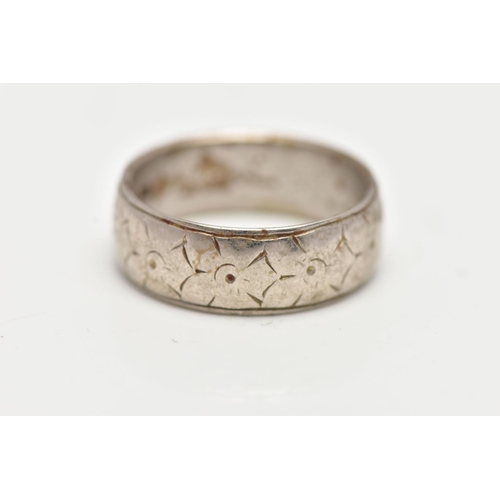 24 - A WHITE METAL WIDE BAND RING, featuring a worn floral engraving, approximate width 6.1mm, stamped 18... 