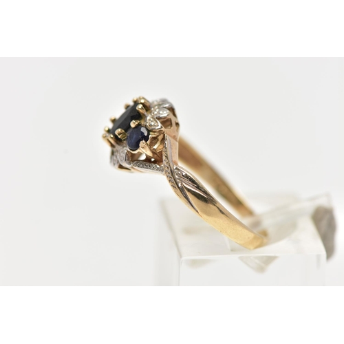 28 - A 9CT GOLD CLUSTER RING, of a circular form, set with an oval and two circular cut blue sapphires, w... 