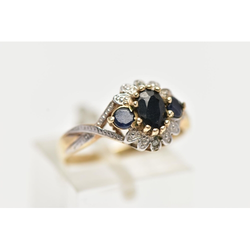 28 - A 9CT GOLD CLUSTER RING, of a circular form, set with an oval and two circular cut blue sapphires, w... 