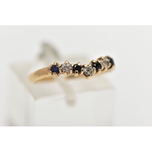 29 - A 9CT GOLD SAPPHIRE AND CUBIC ZIRCONIA WISHBONE RING, set with four circular cut blue sapphires inte... 