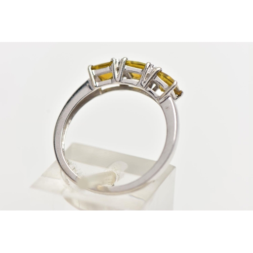 30 - A WHITE GOLD GEM SET RING, set with three square cut yellowish/green stones, interspaced with single... 