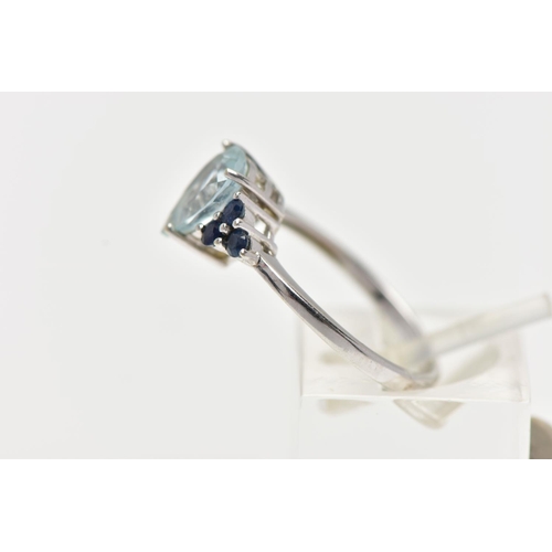 31 - A 9CT WHITE GOLD GEM SET RING, set with a pear cut aquamarine, flanked each side with three circular... 