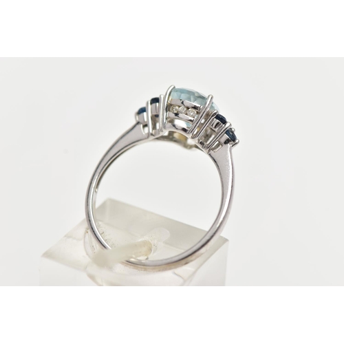 31 - A 9CT WHITE GOLD GEM SET RING, set with a pear cut aquamarine, flanked each side with three circular... 