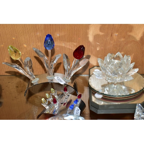 311 - A GROUP OF SWAROVSKI CRYSTAL comprising an 'open shell' 7624, 'Tulips' with chrome stands, a 2002 15... 