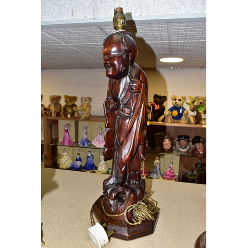 374 - A LARGE WOODEN FIGURAL TABLE LAMP, a hand carved figure of Chinese Shou Lao (god of Longevity), lotu... 