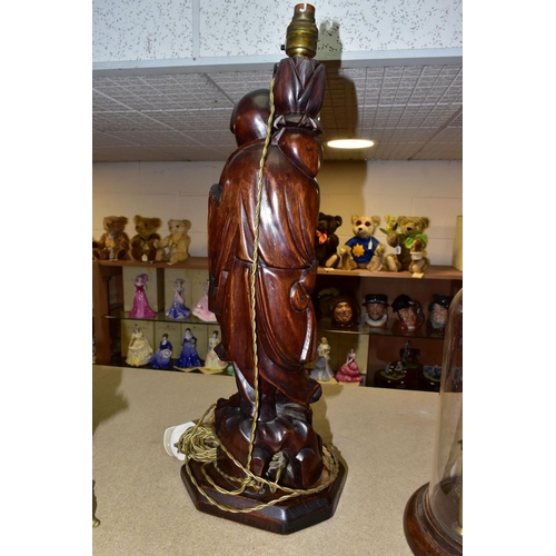 374 - A LARGE WOODEN FIGURAL TABLE LAMP, a hand carved figure of Chinese Shou Lao (god of Longevity), lotu... 