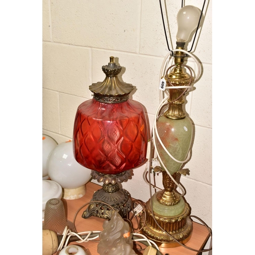 409 - TWO VINTAGE TABLE LAMPS AND A GROUP OF ASSORTED GLASS SHADES, comprising a large green onyx and gilt... 