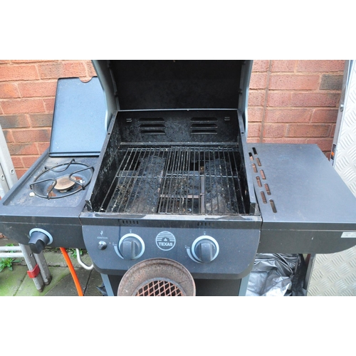 1007 - A TEXAS GAS BARBECUE with a single burner and shelf flanking central covered section and cover 110cm... 