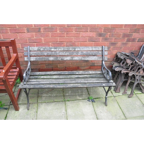 1009 - A WOODEN SLATTED HARDWOOD GARDEN BENCH 154cm wide, a garden bench with cast iron ends, slatted seat ... 