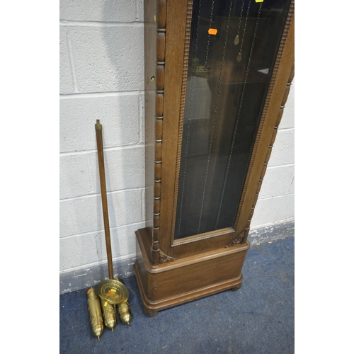 1205 - AN EARLY 20TH CENTURY OAK LONGCASE CLOCK, with a rounded top, single long glazed door enclosing a br... 