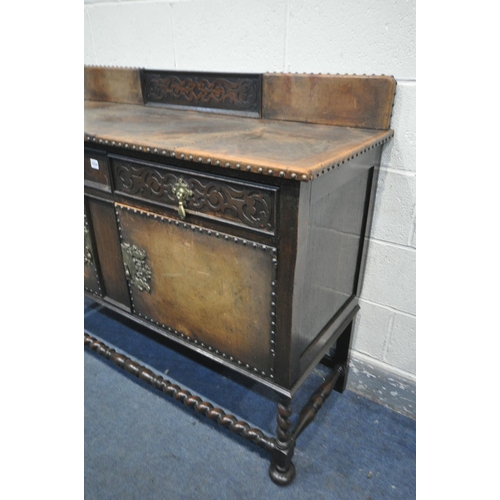 1254 - A 20TH CENTURY OAK SIDEBOARD, with a raised back, two drawers over two cupboard doors, on barley twi... 