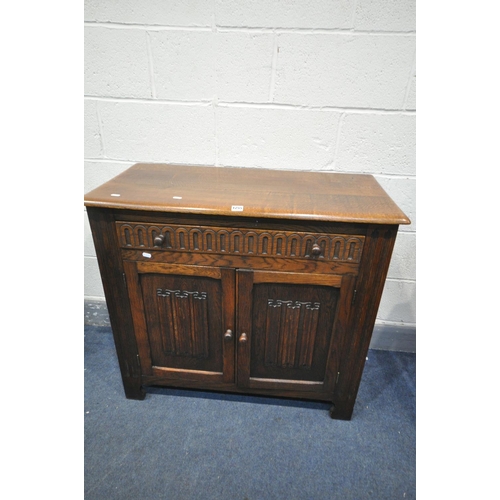 1255 - AN OAK LINENFOLD SIDEBOARD, with two drawers, width 93cm x depth 43cm x height 84cm (condition:-good... 