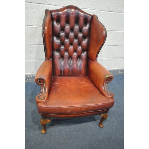 1258 - A GEORGIAN STYLE OXBLOOD LEATHER BUTTONED WING BACK ARMCHAIR, with swept armrests, on front cabriole... 