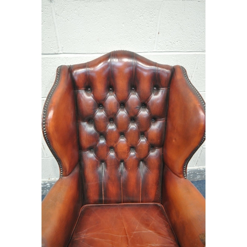 1258 - A GEORGIAN STYLE OXBLOOD LEATHER BUTTONED WING BACK ARMCHAIR, with swept armrests, on front cabriole... 