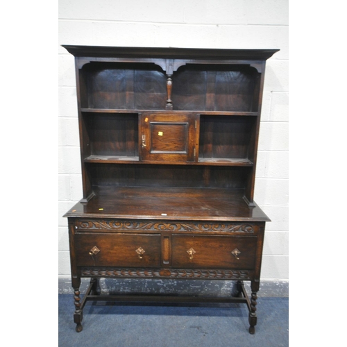 1263 - AN EARLY TO MID 20TH CENTURY OAK DRESSER, with an arrangement of shelves, above a base with two draw... 