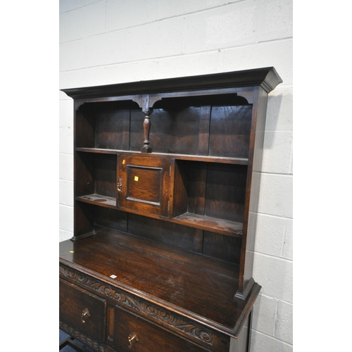 1263 - AN EARLY TO MID 20TH CENTURY OAK DRESSER, with an arrangement of shelves, above a base with two draw... 