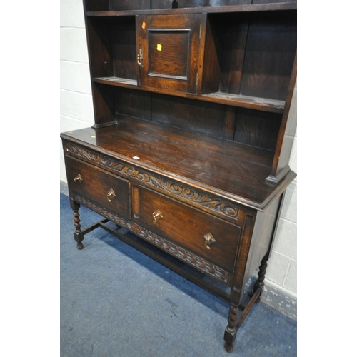 1263 - AN EARLY TO MID 20TH CENTURY OAK DRESSER, with an arrangement of shelves, above a base with two draw... 