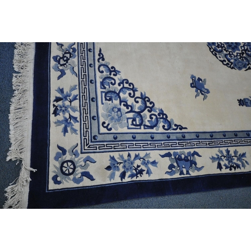 1266 - A CHINESE CREAM AND BLUE WOOLLEN CARPET, 370cm x 275cm (condition:-in need of cleaning)