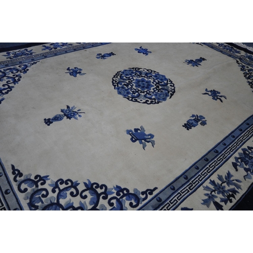 1266 - A CHINESE CREAM AND BLUE WOOLLEN CARPET, 370cm x 275cm (condition:-in need of cleaning)