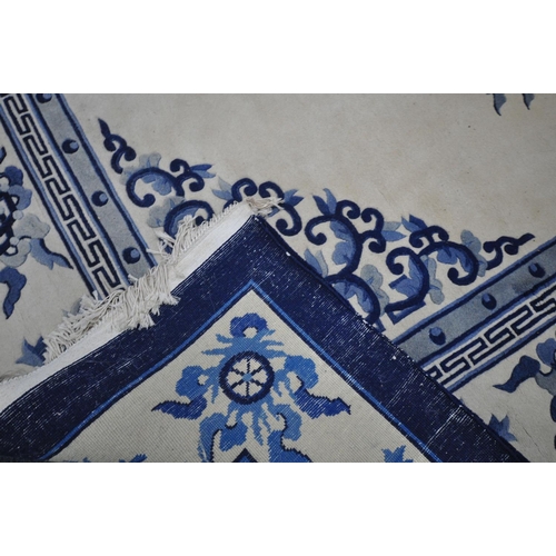 1266 - A CHINESE CREAM AND BLUE WOOLLEN CARPET, 370cm x 275cm (condition:-in need of cleaning)