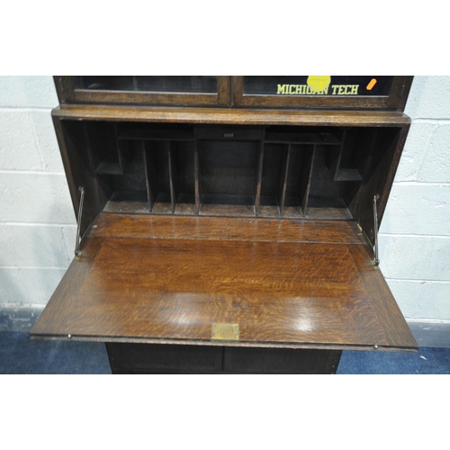 1271 - AN OAK SECTIONAL BOOKCASE/BUREAU, the top two sections with double glazed doors, fall front bureau, ... 