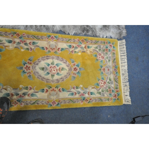 1281 - A CHINESE YELLOW RUG, 160cm x 77cm, and faux fur rug (2)