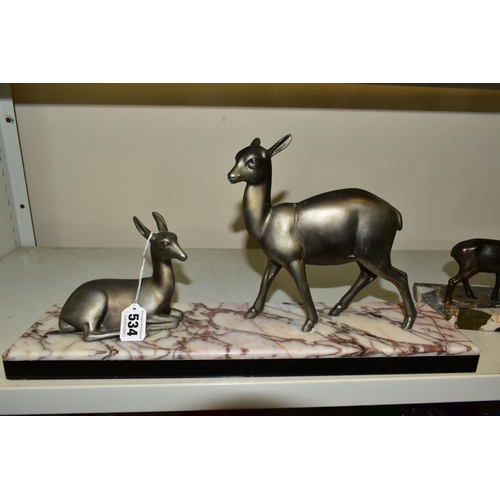 534 - A FRENCH ART DECO SCULPTURE OF TWO DEER, one lying one standing, mounted to a marble base, approxima... 