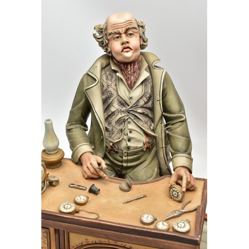 1127A - A CAPODIMONTE PORCELAIN TABLEAU 'THE CLOCK MAKER', sculpted by Mario Angela, modelled as a gentelamn... 