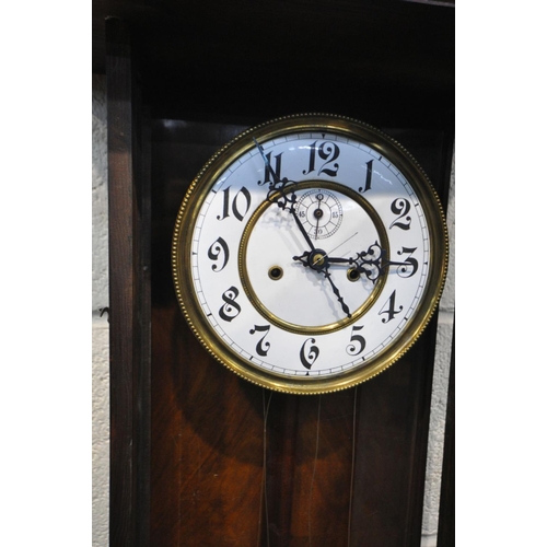 1199 - A LATE 19TH CENTURY WALNUT VIENNA WALL CLOCK, half turned fluted pillars to the door, enclosing an e... 