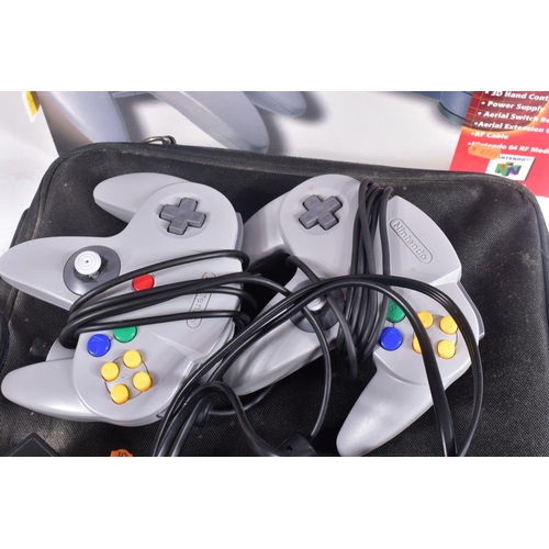 209 - TWO BOXED NINTENDO 64 CONSOLES, CONTROLLERS AND A QUANTITY OF GAMES, N64s that are boxed are not the... 