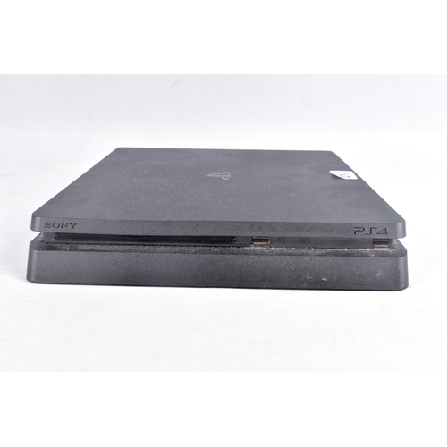 214 - A PLAYSTATION 4 SLIM CONSOLE AND CONTROLLER, console is noteably dirty, but is in working condition ... 