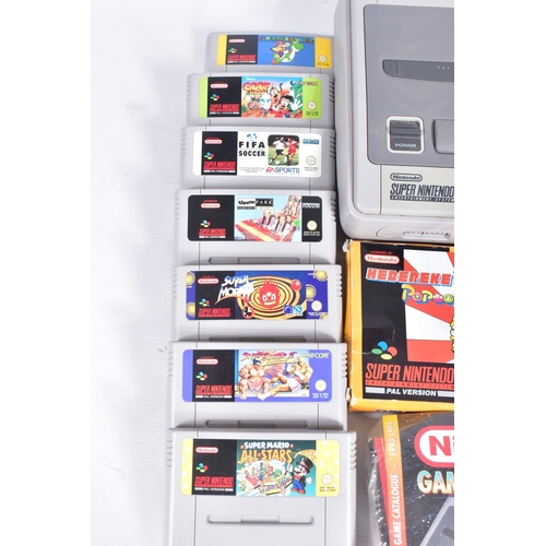 221 - SNES CONSOLE AND QUANTITY OF GAMES, games include Super Mario World, Super Mario All Stars, Street F... 