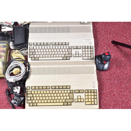 229 - TWO AMIGA A-500 COMPUTERS, GAMES AND ACCESSORIES, acessories include mice and joysticks, games consi... 