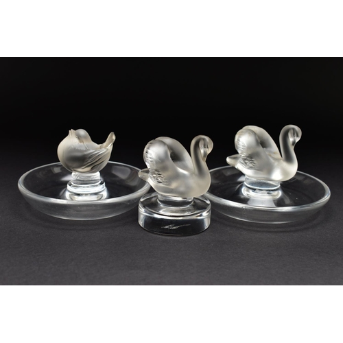 101 - TWO LALIQUE RING / PIN TRAYS AND A LALIQUE PAPERWEIGHT, the two clear glass ring trays with a froste... 