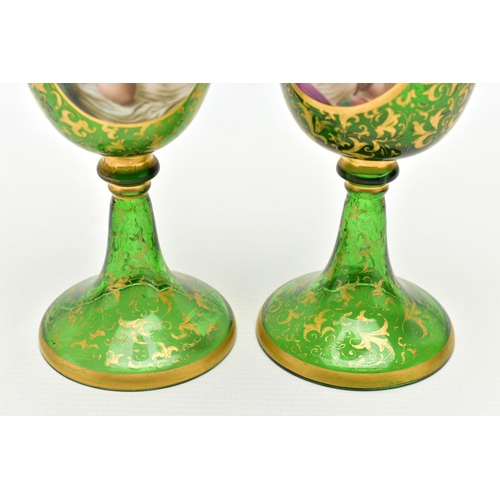 106 - A PAIR OF 19TH CENTURY BOHEMIAN GREEN AND GILT GLASS PEDESTAL EWERS OF HELMET FORM, each with a whit... 