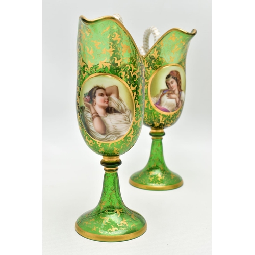 106 - A PAIR OF 19TH CENTURY BOHEMIAN GREEN AND GILT GLASS PEDESTAL EWERS OF HELMET FORM, each with a whit... 