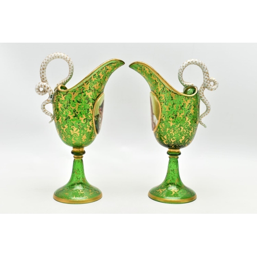 106 - A PAIR OF 19TH CENTURY BOHEMIAN GREEN AND GILT GLASS PEDESTAL EWERS OF HELMET FORM, each with a whit... 