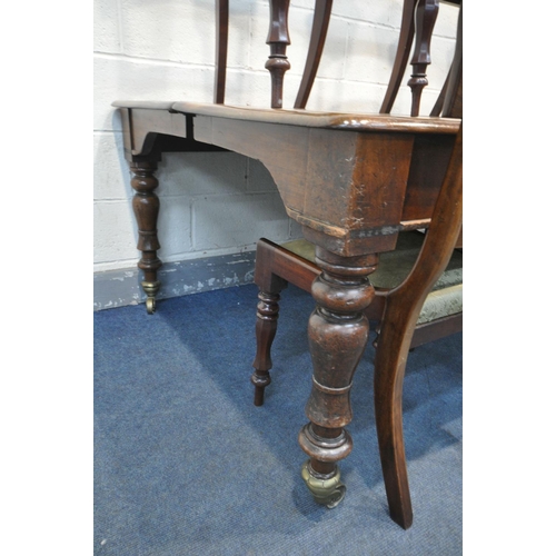 227 - A REGENCY FLAME MAHOGANY DINING TABLE, on eight turned legs with large brass caps and casters, break... 