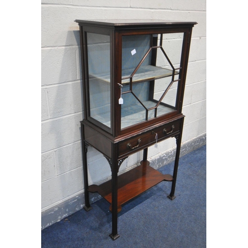 228 - A LIBERTY OF LONDON EDWARDIAN MAHOGANY DISPLAY CABINET, the single astragal glazed door enclosing a ... 