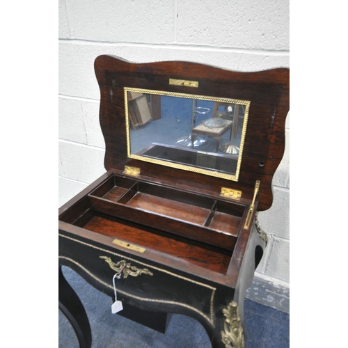 231 - A NAPOLEON III EBONISED AND GILT SERPENTINE WORK TABLE, the hinged top enclosing a rosewood interior... 