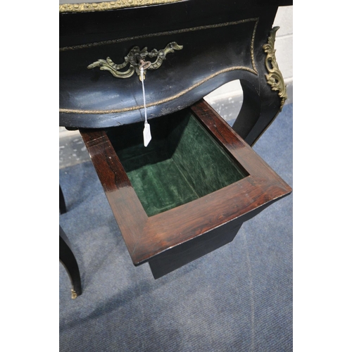 231 - A NAPOLEON III EBONISED AND GILT SERPENTINE WORK TABLE, the hinged top enclosing a rosewood interior... 