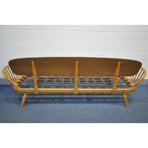 237 - LUCIAN ERCOLANI FOR ERCOL, A MODEL 355 ELM AND BEECH STUDIO COUCH, with a surfboard back and spindle... 