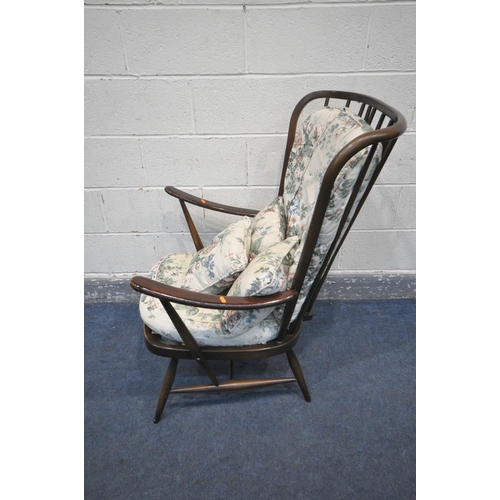 239 - A DARK ERCOL WINDSOR ARMCHAIR, with floral cushions (condition:- this chair does not comply with the... 