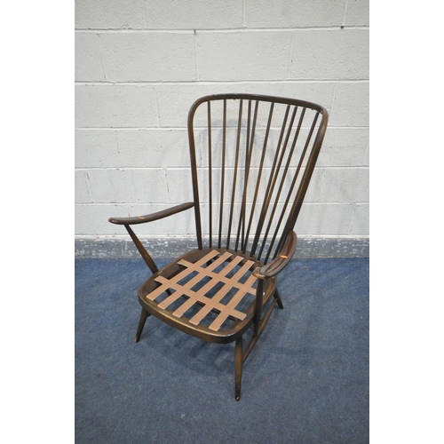 239 - A DARK ERCOL WINDSOR ARMCHAIR, with floral cushions (condition:- this chair does not comply with the... 