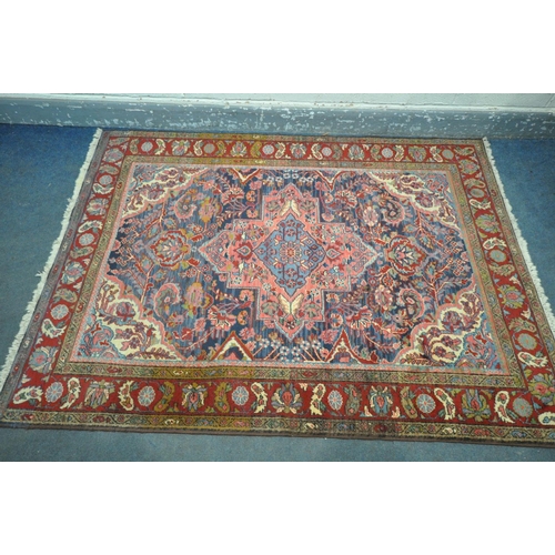 249 - A KASHAN STYLE BLUE GROUND RUG, with a foliate multistrap border, with a central medallion 203cm x 1... 