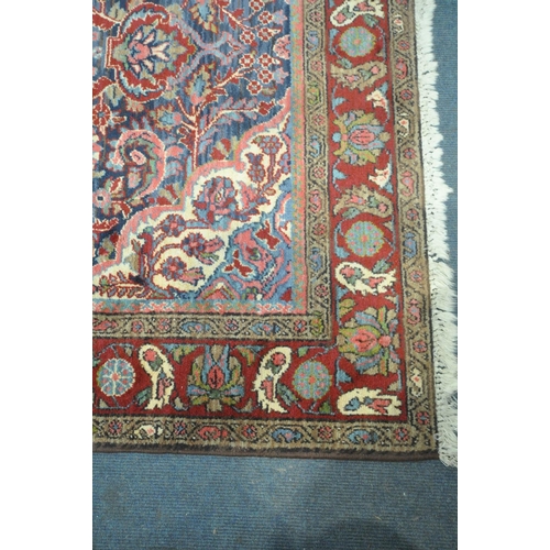 249 - A KASHAN STYLE BLUE GROUND RUG, with a foliate multistrap border, with a central medallion 203cm x 1... 