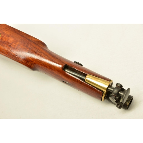 335 - AN ANTIQUE 19 BORE SINGLE BARREL PERCUSSION PISTOL fitted with a 8¼  barrel and  hinged ramrod, the ... 