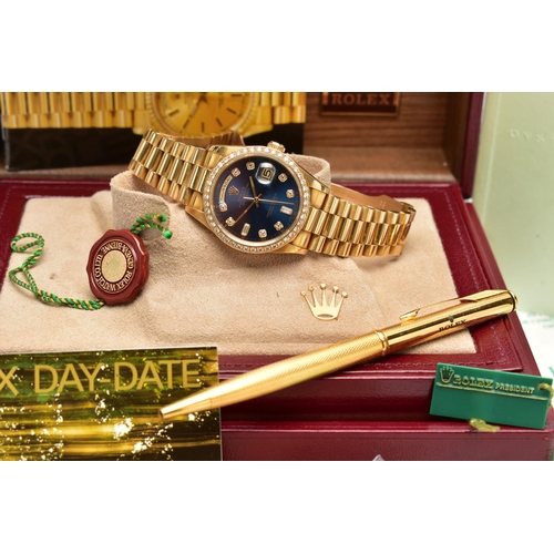 5 - AN 18CT YELLOW GOLD AND DIAMOND DAY-DATE ROLEX WRISTWATCH, the dark blue dial with diamond dot hourl... 