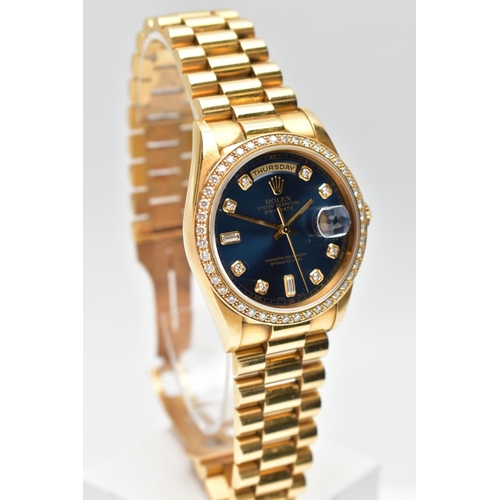 5 - AN 18CT YELLOW GOLD AND DIAMOND DAY-DATE ROLEX WRISTWATCH, the dark blue dial with diamond dot hourl... 