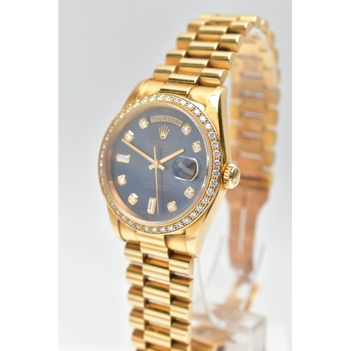 5 - AN 18CT YELLOW GOLD AND DIAMOND DAY-DATE ROLEX WRISTWATCH, the dark blue dial with diamond dot hourl... 